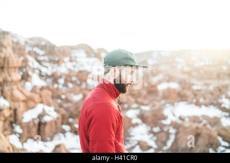 A hiker admires the stunning view of the winter canyon in southern Utah Stock Photo