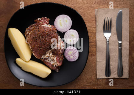 raw pork steak still life on wooden background prepare food rustic cooking herbs Stock Photo