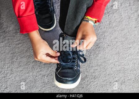 Boy tying shoelaces Stock Photo