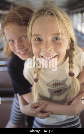 Train compartment, girl, happy, embrace, detail, portrait, inside, summer, vacation, holidays, leisure time, childhood, children, 9 years, fun, excursion, travel, train travel, train journey, trajectory, railway car, carriage, laugh, amuse funnily, joy, h Stock Photo