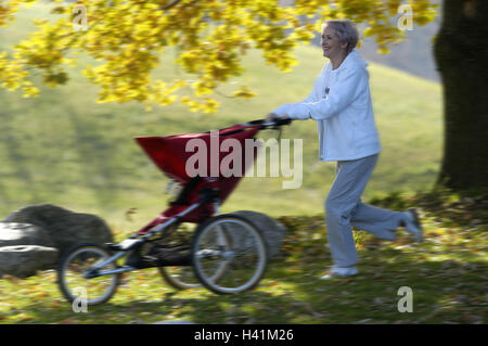 Park, senior, baby jogger, run, jog side view, autumn park, woman, 50-60 years, Best Age, granny, pensioner, Jung-remaining, grandmother, sportily, baby carriages, walk, park, sport, activity, actively, fit, agile, health, fitness, leisure time, jogger, jogging, happy, joy, joy life, laugh, amusements, lifestyle, autumnally, season, 60-70 years, Stock Photo