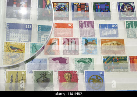 Stamps, internationally, loupe, detail, at collection, at stamp collection, collective notebook, philatelic notebook, retention, ordered, order, arranged, hobby, leisure activity, fascination, loupe, consideration glass, look, accuracy, value, stamp, post Stock Photo