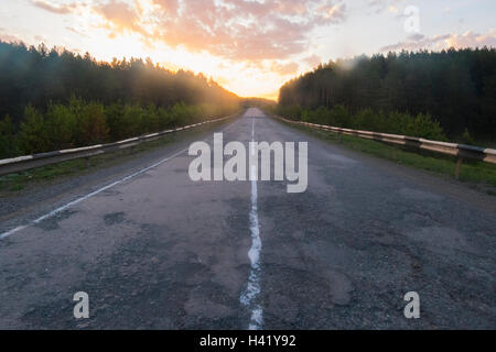 Sunset over empty freeway Stock Photo