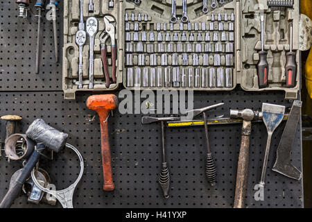 Tools hanging on pegboard Stock Photo