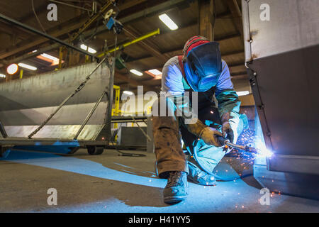 Caucasian man welding metal in factory Stock Photo