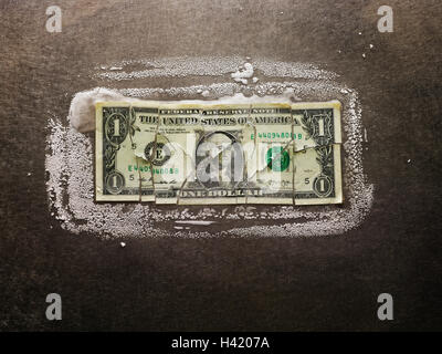 Frozen broken dollar bill Stock Photo