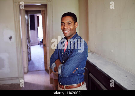 Smiling man posing in empty house Stock Photo