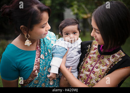 Mother and daughter admiring baby boy Stock Photo