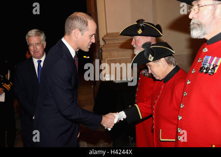 The Duke of Cambridge speaks to Chelsea Pensioner Barbara Whilds whilst attending the MOD Employer Recognition Scheme Gold Awards being held at the Royal Hospital Chelsea in London. Stock Photo