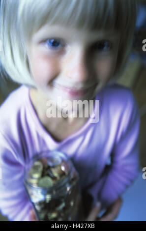 Girls, smiles, glass, filled,  Euro coins, holds, portrait,  broached, fuzziness Child portrait, child, toddler, 4-6 years, blond, happily, pride, jam glass, money, Euro, Euros coins change, pocket money, savings, spared, thrift, saved indoors, makes blur Stock Photo