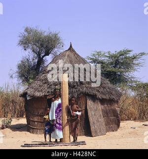 Senegal, Thies region, village, straw hut, woman, children, Peul strain, group picture, Africa, West, Africa, Senegal, Thies region, ethnic group, tribe Peul, people, four, Senegalese, dark-skinned, nut, siblings, girls, baby, carry, mats, straw mats, twisted, manual labours, Flechtarbeit, point, present, pose, outside, Stock Photo