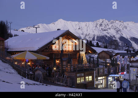 Austria, Tyrol, Fiss, witch's alp, lighting, dusk, alps, winter sports area, skiing area, tourism, tourism, ski hut, hut, wooden hut, alp, gastronomy, Apres ski, lights, dusk, person, tourism, ski vacation, outside, Stock Photo