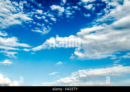 Cumulus clouds are gathering on sunny sky before the rain Stock Photo