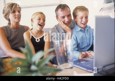 Family, laugh, together, laptop, play family life, leisure time, together, family luck, couple, 30-40 years, children, son, subsidiary, girl, boy, two, 6 - 10 years, computers, notebook computer, to computer games, fun, leisure activity, sitting room, sof Stock Photo