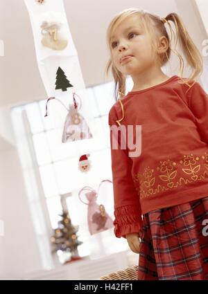 Advent,Advent calendar,Advent time,Christmas,Christmas time,blond,calendar,child,childhood,dirty,excitement,girl,inside,lighthearted,little bag,mouth,naturalness,prejoy,smeared,surprise,x-mas Stock Photo