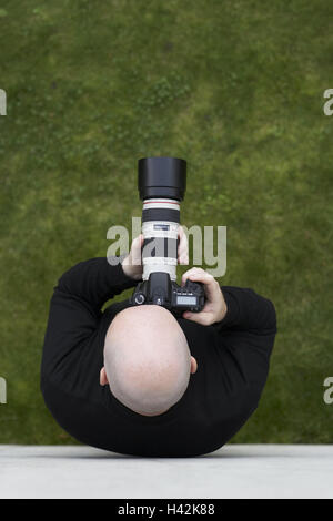 Man, bald head, camera, lens, take photos, outside, from above, Glatzkopf, head, bald, hands, camera, photo camera, hold, meadow, stand, photo, picture, take pictures, observe, enlargement, view, proof, interest, curiosity, spying, observation, fruit picker's crossing, keep under surveillance, private detective, track down, shade, shadowing, photographer, hobby, occupation, turfs, green, icon, conception, Stock Photo