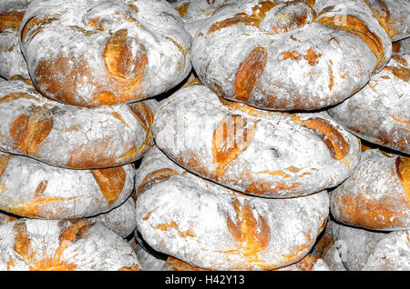 Big round breads for sale at a medieval bakery stall. Village's food. Stock Photo