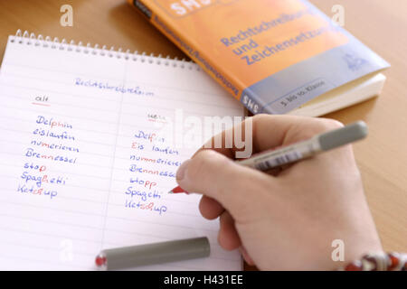 Spelling reform, schoolboy, detail, hand, Duden, block, comparison, manner writing, old, anew, pen, curled spelling, orthography, language, German, regulation, reform, update, updates, look up, look, confusion, writing pad, words, book, reference book, ru Stock Photo