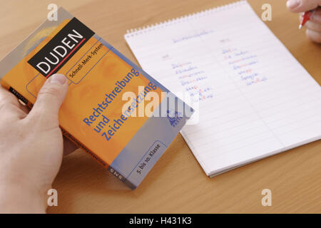 Spelling reform, schoolboy, detail, hand, Duden, block, comparison, manner writing, old, anew, pen, curled spelling, orthography, language, German, regulation, reform, update, updates, look up, look, confusion, writing pad, words, book, reference book, ru Stock Photo