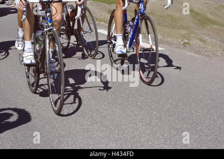 Street, racing cyclist, go, uphill, detail, no model release, France, racing wheels, bicycles, cycling, sport, bicycle driving, motion, feet, bicycle shoes, radian shoes, step, strain, hobby, leisure time, perseverance, condition, person, group, nature, sunshine, shade, Stock Photo