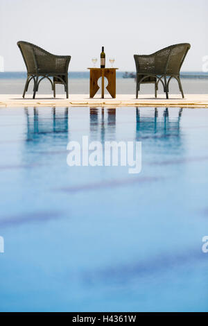 Pool, chairs, table, wine bottle, glasses, sea gaze, Stock Photo