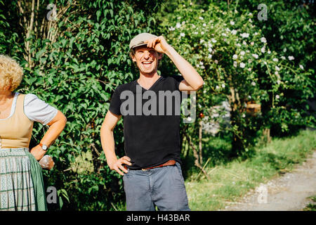 Smiling Caucasian man tipping cap Stock Photo