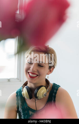 Caucasian woman with headphones around neck Stock Photo