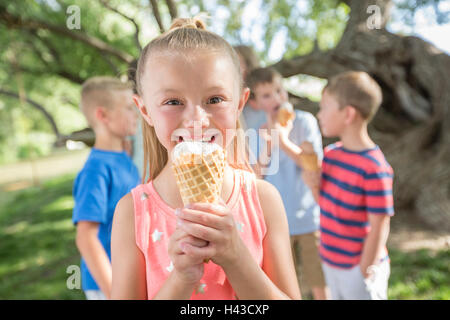 Caucasian girl eating ice cream cone Stock Photo