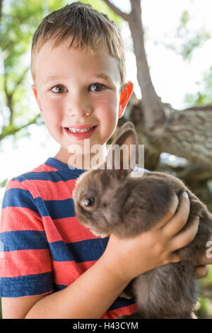 Closeup image of a Domestic rabbit standing in grass Stock Photo - Alamy