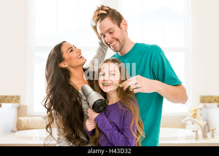 Family grooming each other in bathroom Stock Photo