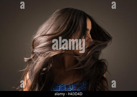 Mixed Race woman tossing hair Stock Photo