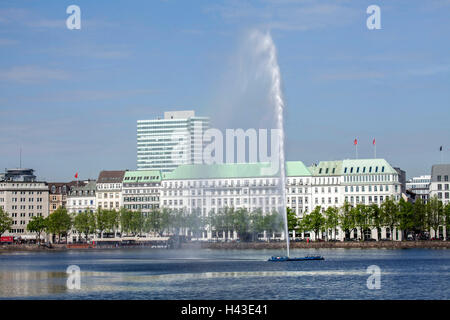 Hotel Vier Jahreszeiten at the Inner Alster Lake with water fountain, Hamburg, Germany Stock Photo