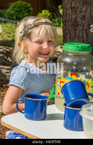 Smiling Caucasian girl selling lemonade Stock Photo