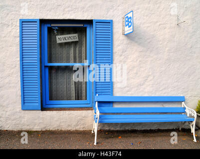 A window of a bed and breakfast displays a ' No Vacancy' sign. Stock Photo