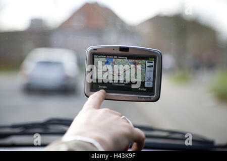 Navigation system in the car, women's hand, service, Stock Photo