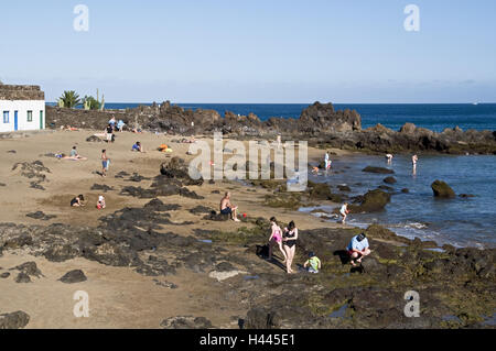 Spain, Canary islands, Lanzarote, Puerto del Carmen, beach, Playa Chica, stones, volcano rock, person, Stock Photo