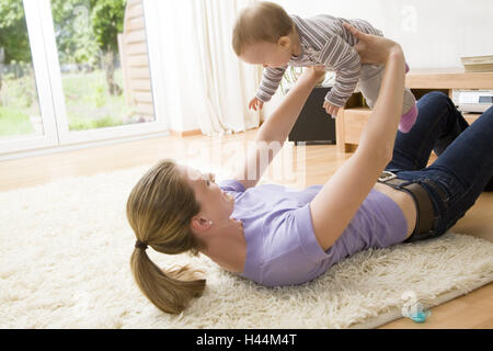 Nut, lie, baby, lift, infant, woman, smile, play home, harmony, love, carpet, affection, together, family luck, care, trust, people, child, inside, floor, happy, together, lift, Stock Photo