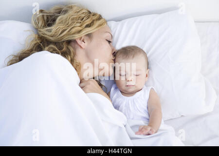 Mother, baby,  bed, lie, rest, people, woman, child, infant, together, motherly love, love, suture, protection, care, happy, pride, nut pride, bedroom, togetherness, inside, touch, nestle up, cuddle, kiss, sleep, cover, sleep, girls, Stock Photo