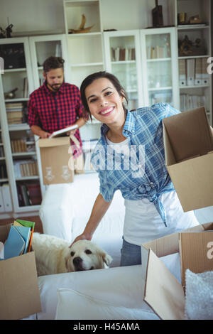 Happy couple unpacking cartons together Stock Photo