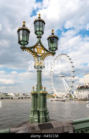 Victorian gas street lantern on Westminster Bridge in London with Millennium wheel in background Stock Photo