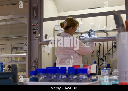 Chemicals companies, laboratory assistant, smock, safety glasses, rehearsal bottle, concentration, Germany, North Rhine-Westphalia, Marl, Evonik, nanotechnology, Nanotronics, company, chemistry, special chemistry, occupation, work, protective clothing, woman, person, employee, scientist, back view, laboratory smock, research, development, laboratory examination, examination, preparation, rehearsal preparation, bottle, science, analysis, evaluation, industry, technology, Stock Photo
