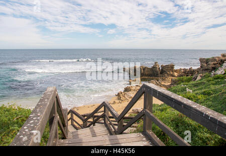 View from wood boardwalk steps overlooking the Indian Ocean seascape with limestone rock at Penguin Island in Western Australia Stock Photo