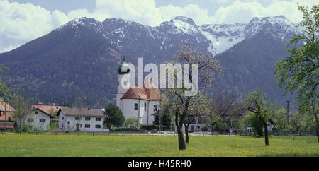 Germany, Bavaria, Werdenfels, Eschenlohe, local view, parish church, St. Clemens, Estergebirge, Europe, South Germany, Upper Bavaria, place, meadow, flower meadow, trees, blossom, spring, church, church, sacred construction, faith, religion, Christianity, mountains, houses, residential houses, Stock Photo