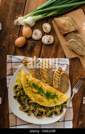 Rustic omelette with mushrooms on chives, roasted panini health bread Stock Photo