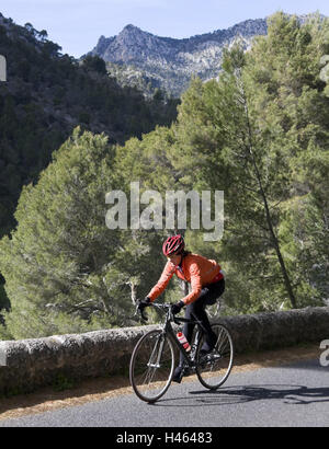 Spain, the Balearic Islands, island Majorca, Tramuntana, mountain road, cyclist, go, uphill, upward, increase, incline, strain, strenuous, mountains, mountains, ride of a bike, drive bicycles, training, coach, sport, cycling, sportily, hobby, street, scenery, nature, spring, person, all alone, racing radian, racing cyclist, Stock Photo