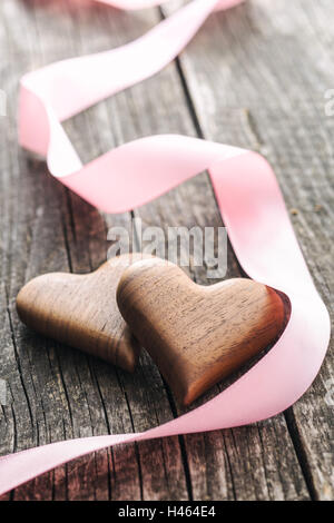Handmade wooden hearts on old wooden table. Stock Photo