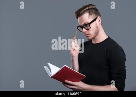 Thoughtful young bearded man in glasses Stock Photo