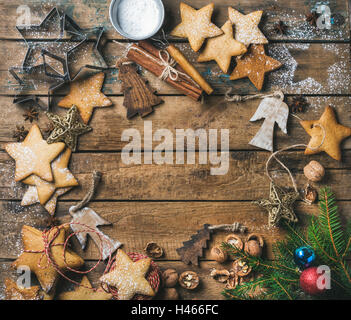 Cookies, nuts, spices, wooden angels and fir branch with balls Stock Photo