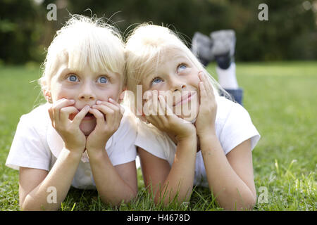 Girls, two, meadow, lie, smile side by side, portrait, person, children, blond, siblings, sisters, friends, view, amazes, is surprised, hands, head, rest on, joy, happy, rest, lazy, there take it easy, with each other, together, childhood, summers, outside, Stock Photo