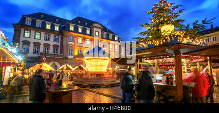 Christmas market in Heidelberg, Germany, a panorama shot at dusk showing illuminated kiosks, architecture and blurred people Stock Photo